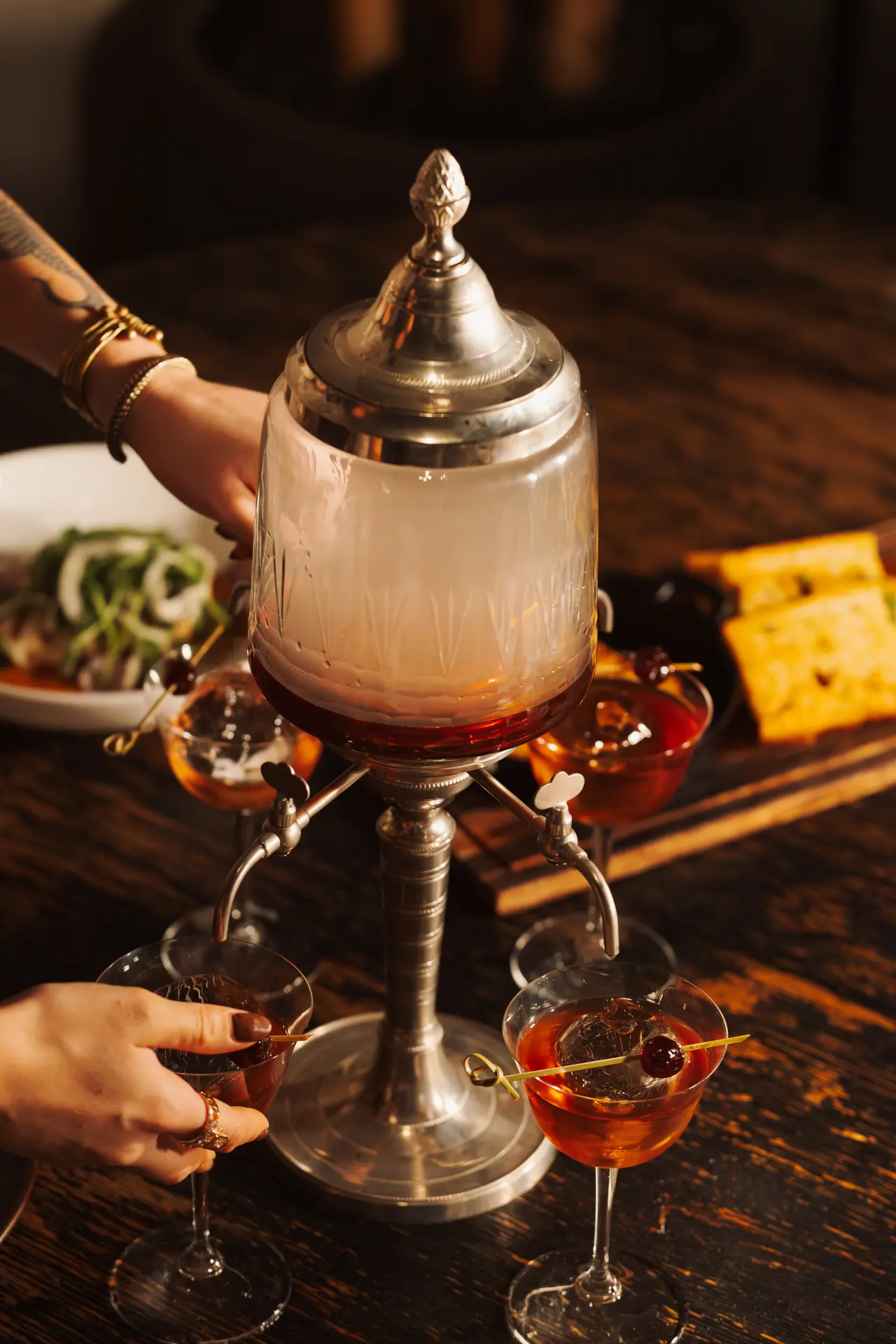 A smoking cocktail tower served at the table